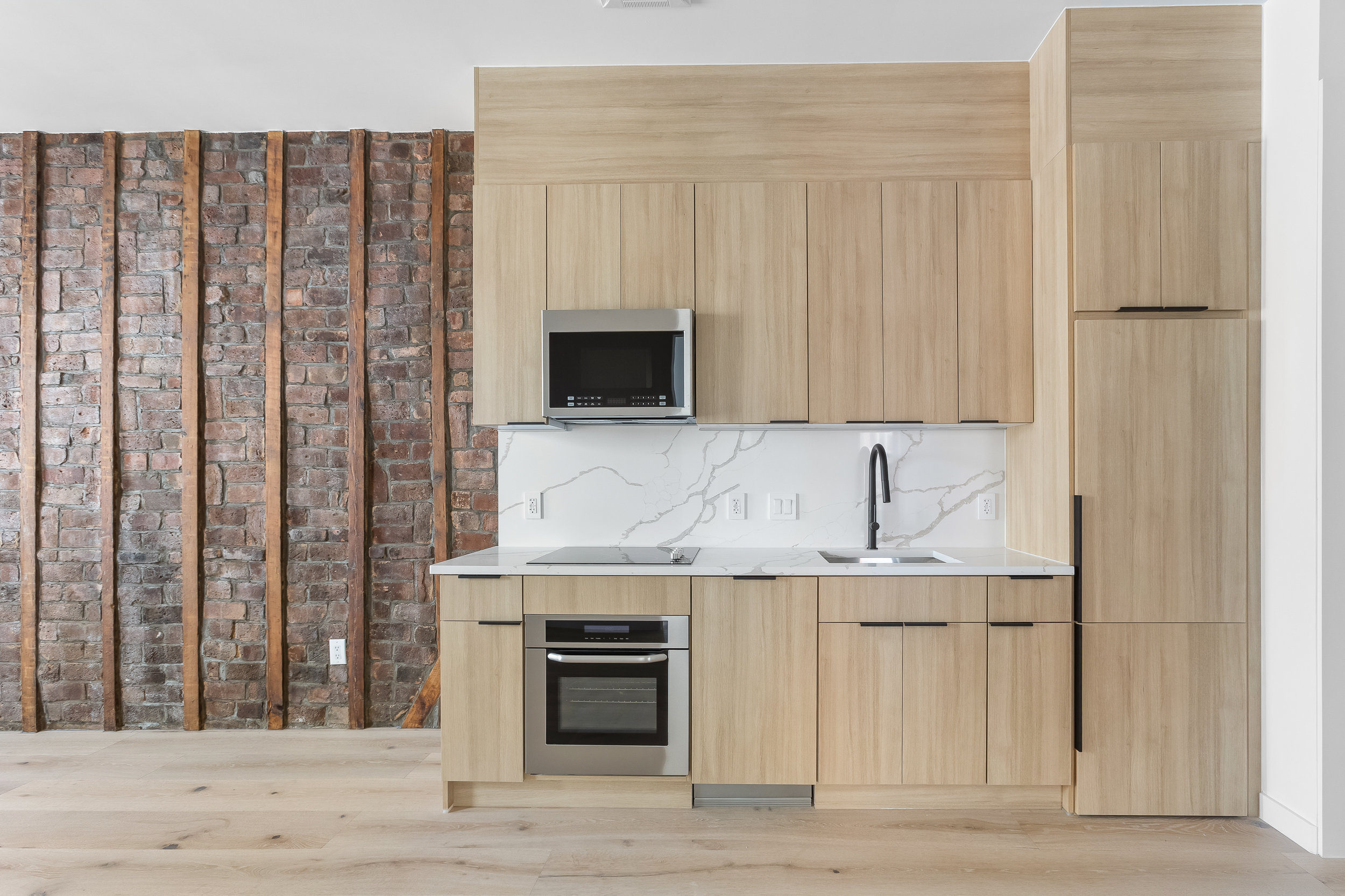 92 Jefferson Street, Unit 4 Brooklyn, NY 11206 - Photo 4 of 9 a kitchen with stainless steel appliances a refrigerator and a stove top oven