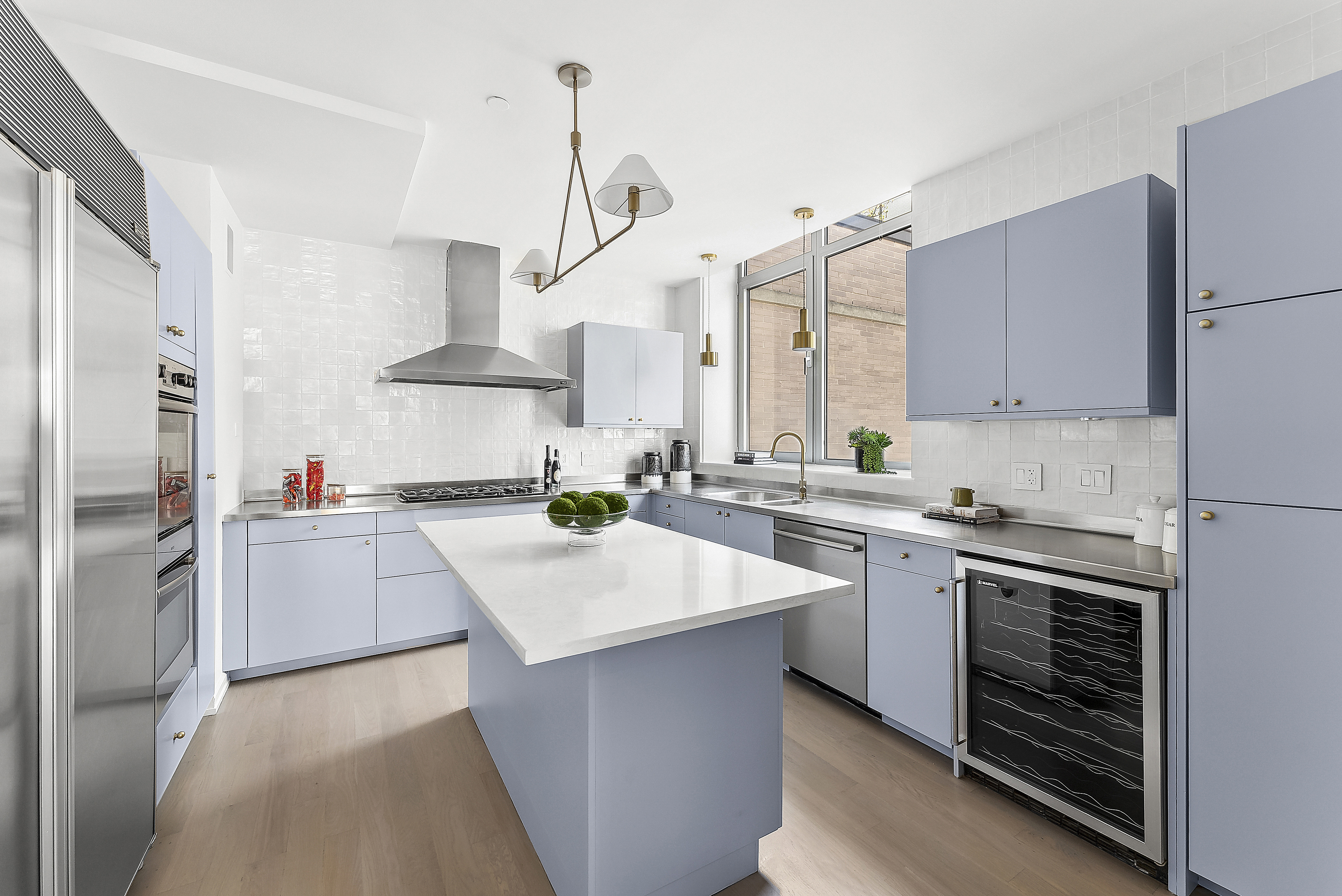 224 West 18th Street, Unit PHA Manhattan, NY 10011 - Photo 7 of 24 a kitchen with stainless steel appliances a sink dishwasher a refrigerator a stove and white cabinets with wooden floor