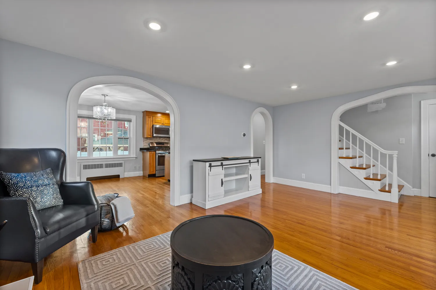 a living room with furniture and a wooden floor