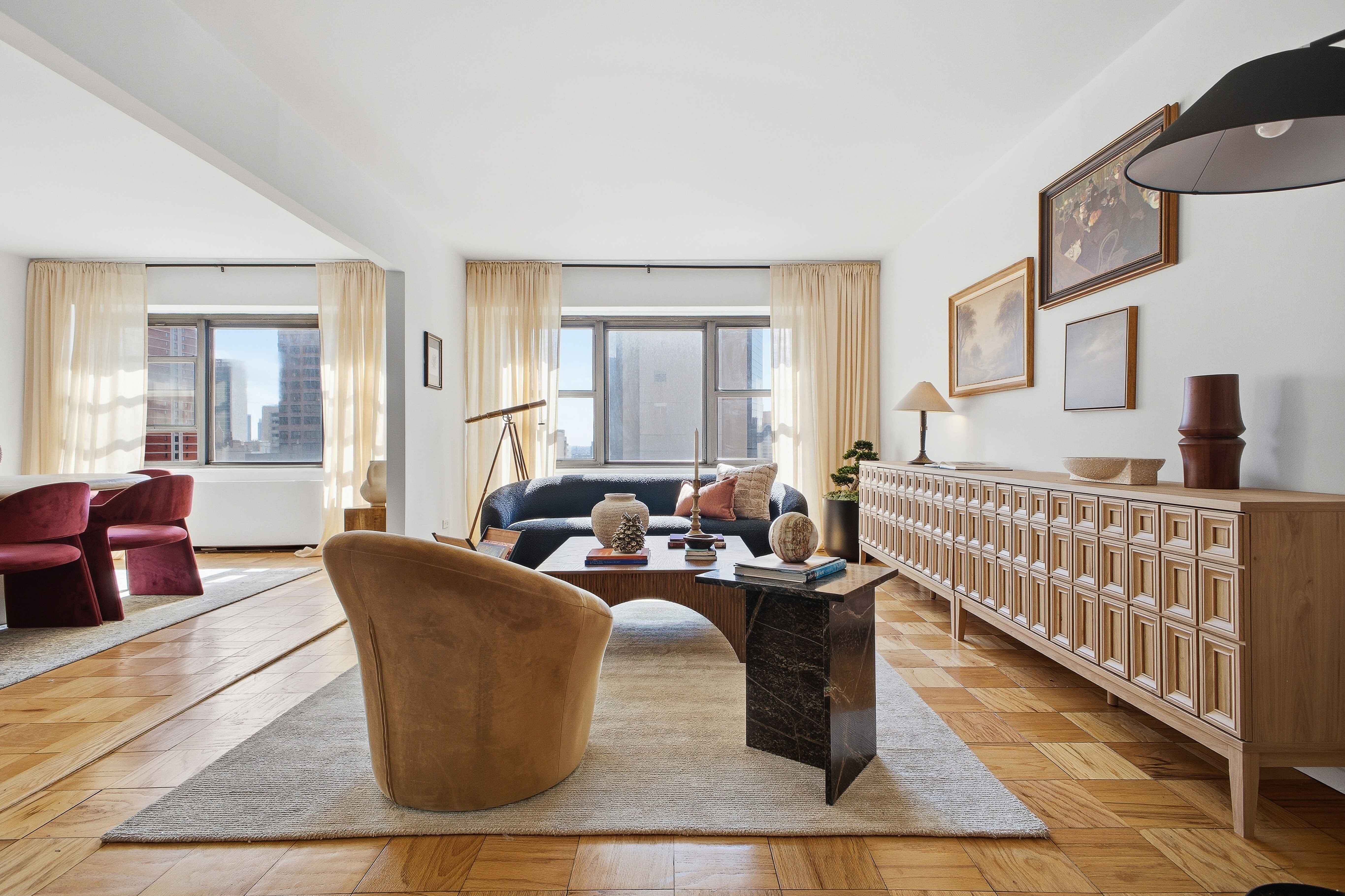 160 East 38th Street, Unit 26FG Manhattan, NY 10016 - Photo 2 of 23 a living room with furniture windows and a wooden floor