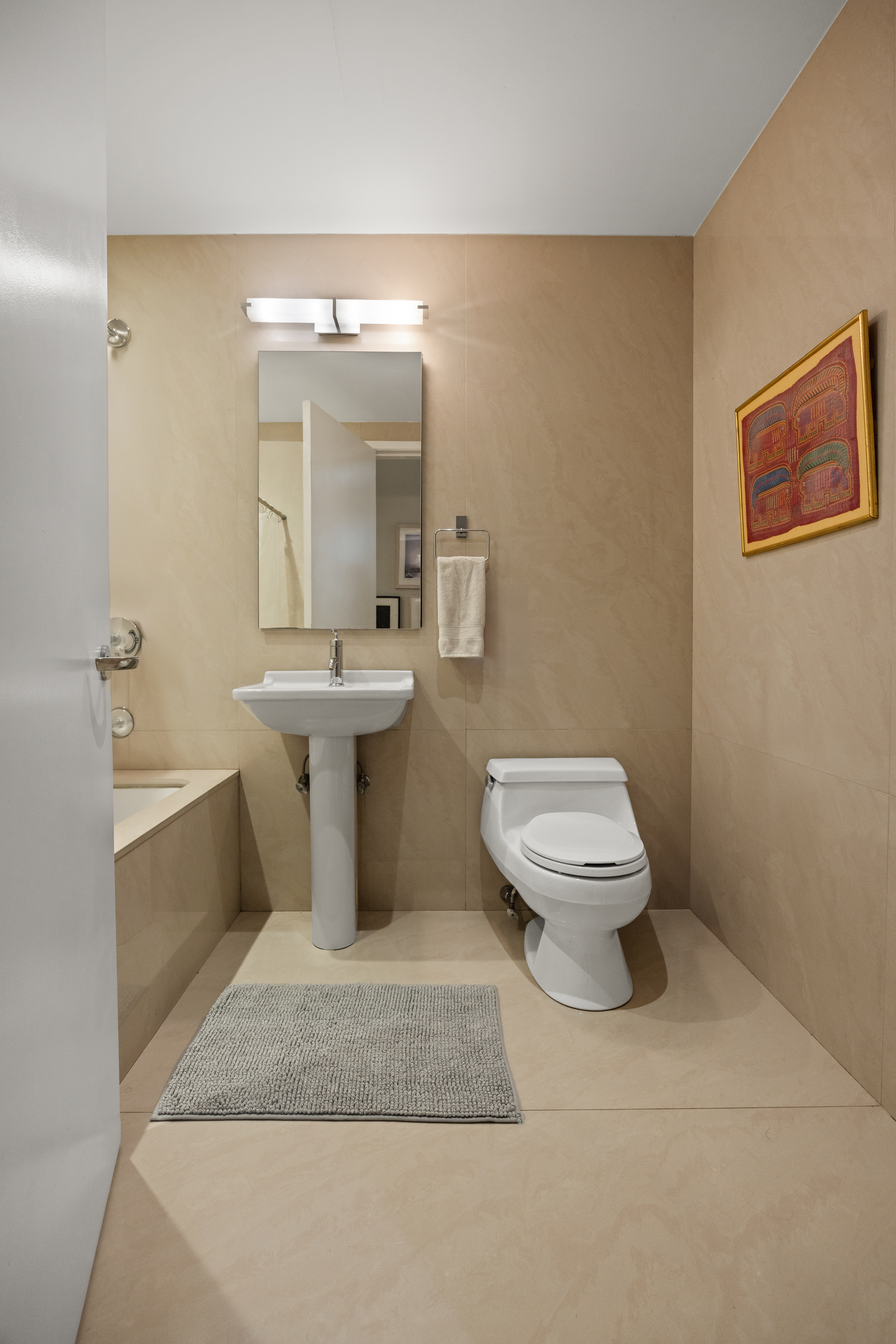 42 Ann Street, Unit 5 Manhattan, NY 10038 - Photo 15 of 16 a bathroom with a toilet sink and mirror