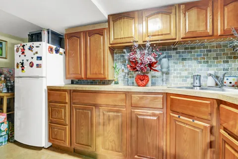 a white refrigerator freezer sitting inside of a kitchen