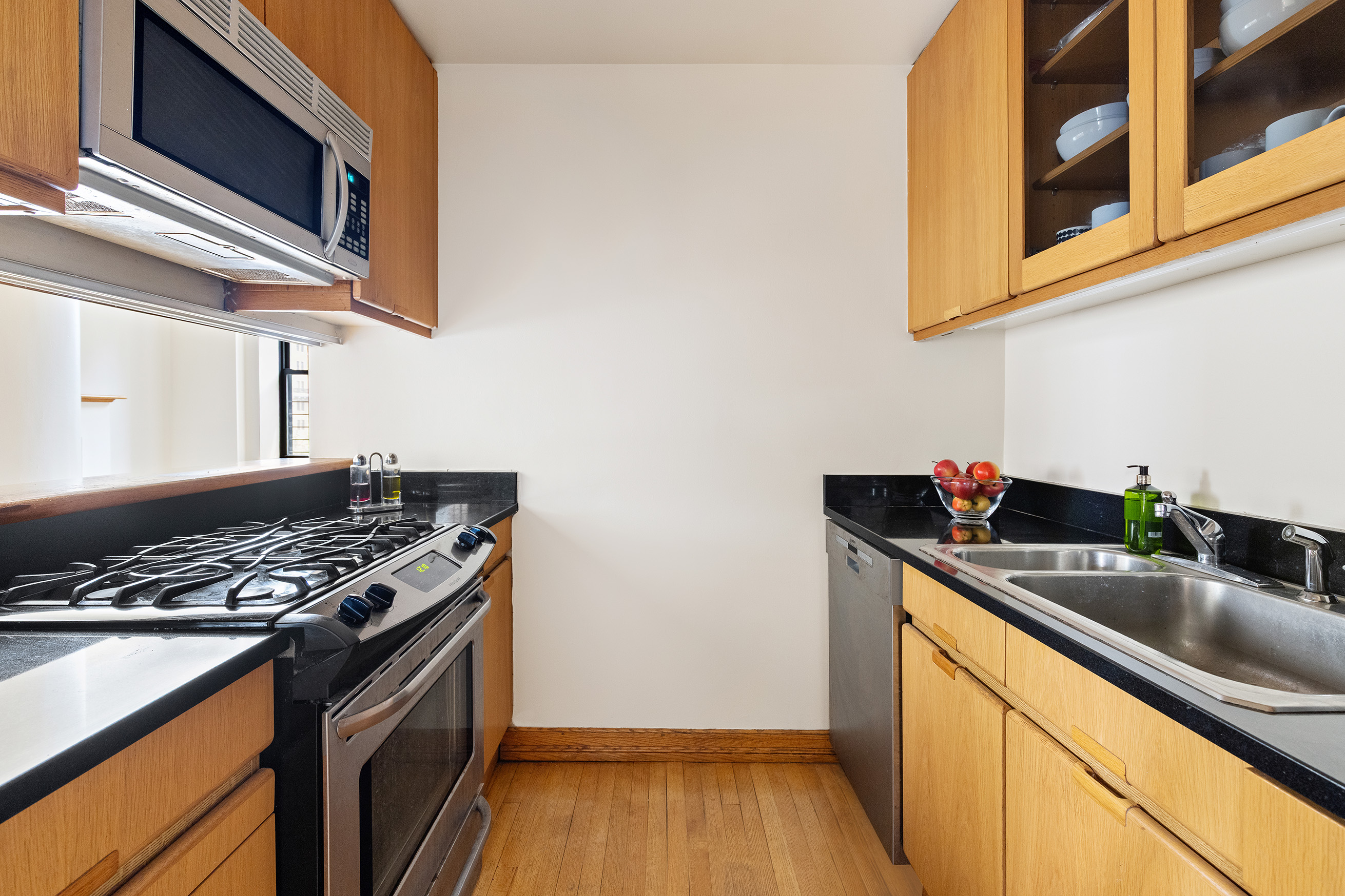 7 Gramercy Park West, Unit 6AB Manhattan, NY 10003 - Photo 3 of 12 a kitchen with stainless steel appliances granite countertop a sink and a stove