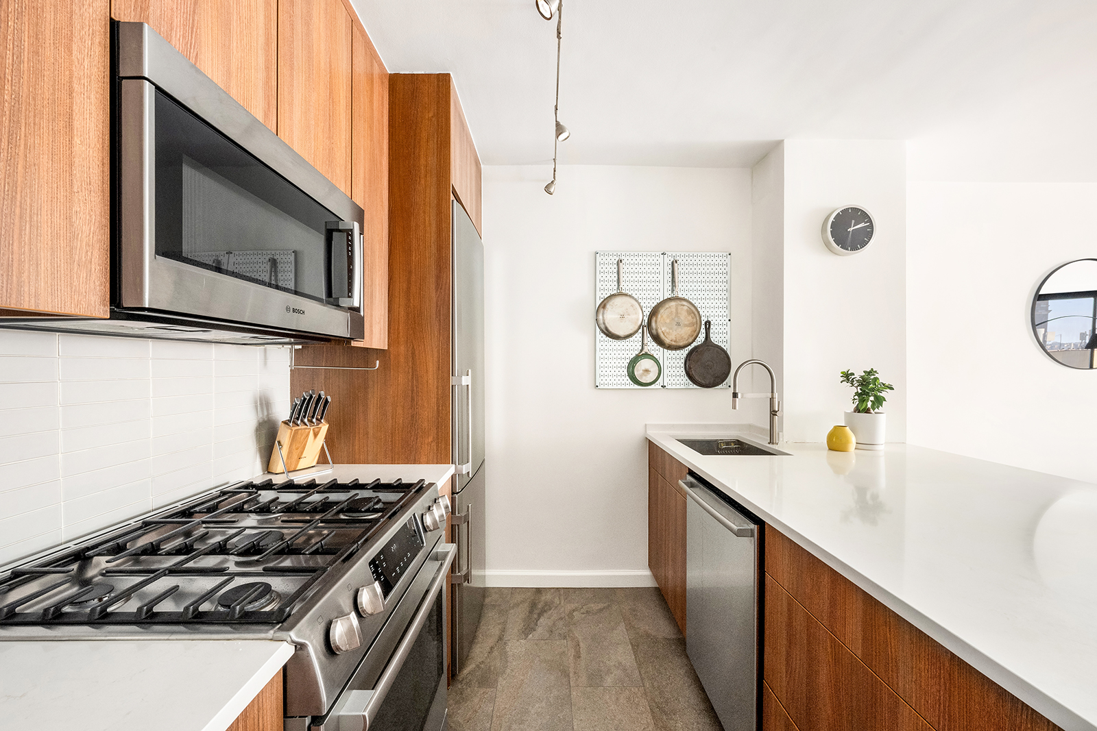 225 West 83rd Street, Unit 8L Manhattan, NY 10024 - Photo 6 of 18 a kitchen with a stove and a sink