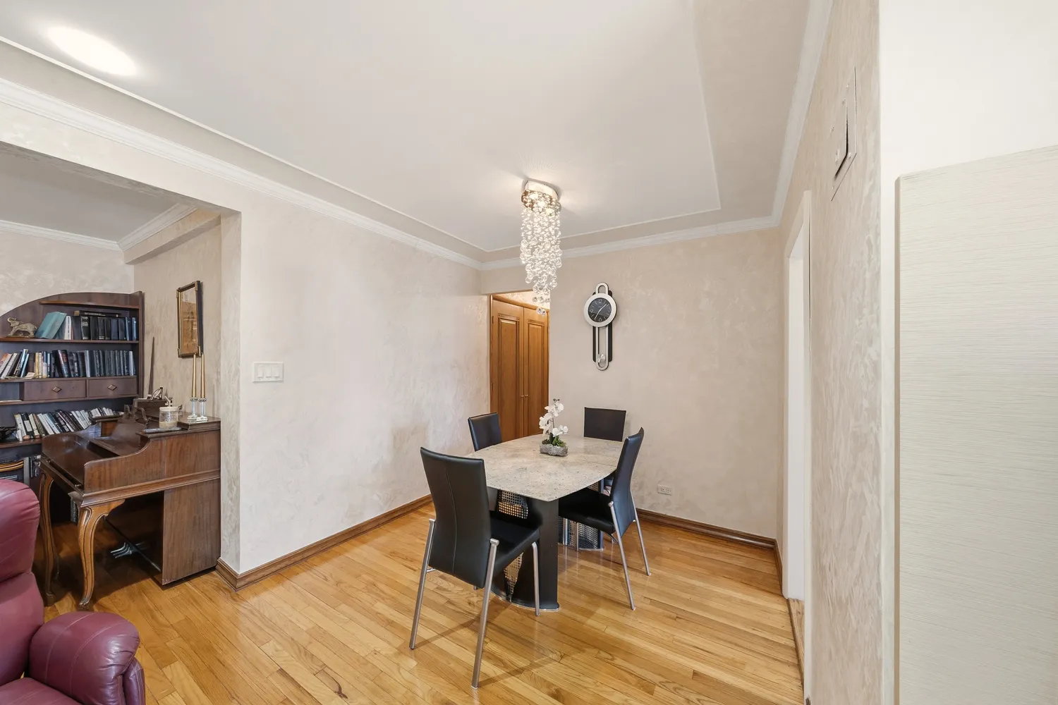 a view of a dining room with furniture and a chandelier