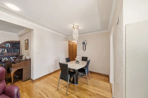 a view of a dining room with furniture and a chandelier