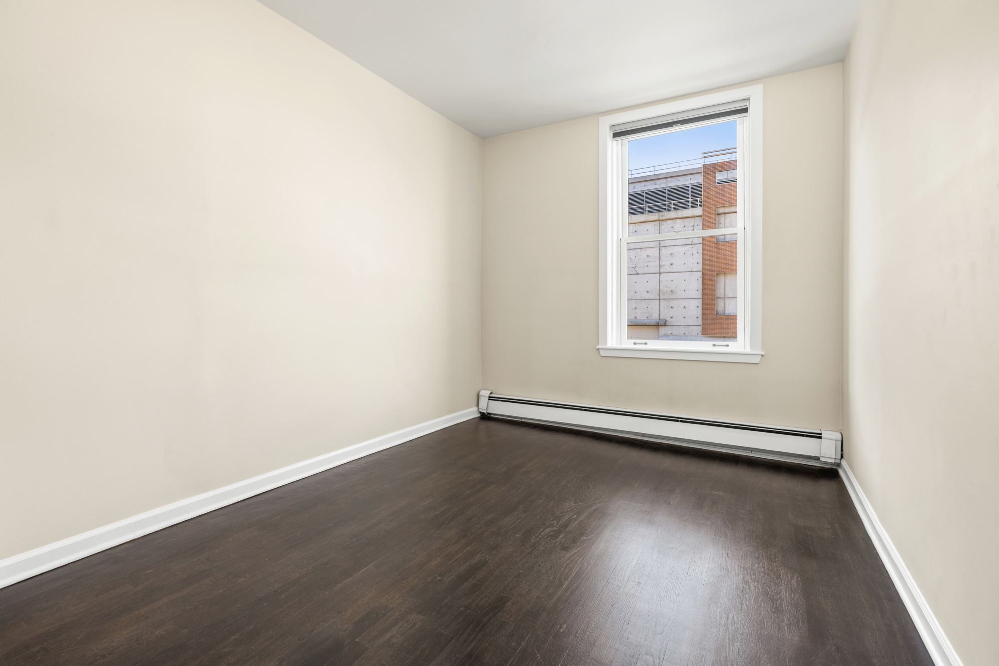 160 West 11th Street, Unit 1 Manhattan, NY 10011 - Photo 12 of 18 an empty room with wooden floor and windows