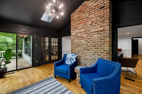 a bedroom with furniture and large windows