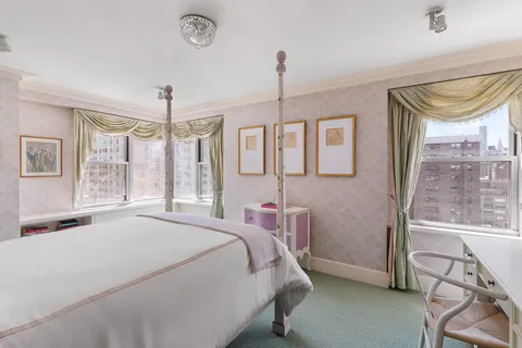 a bedroom with a bed window and wall painting