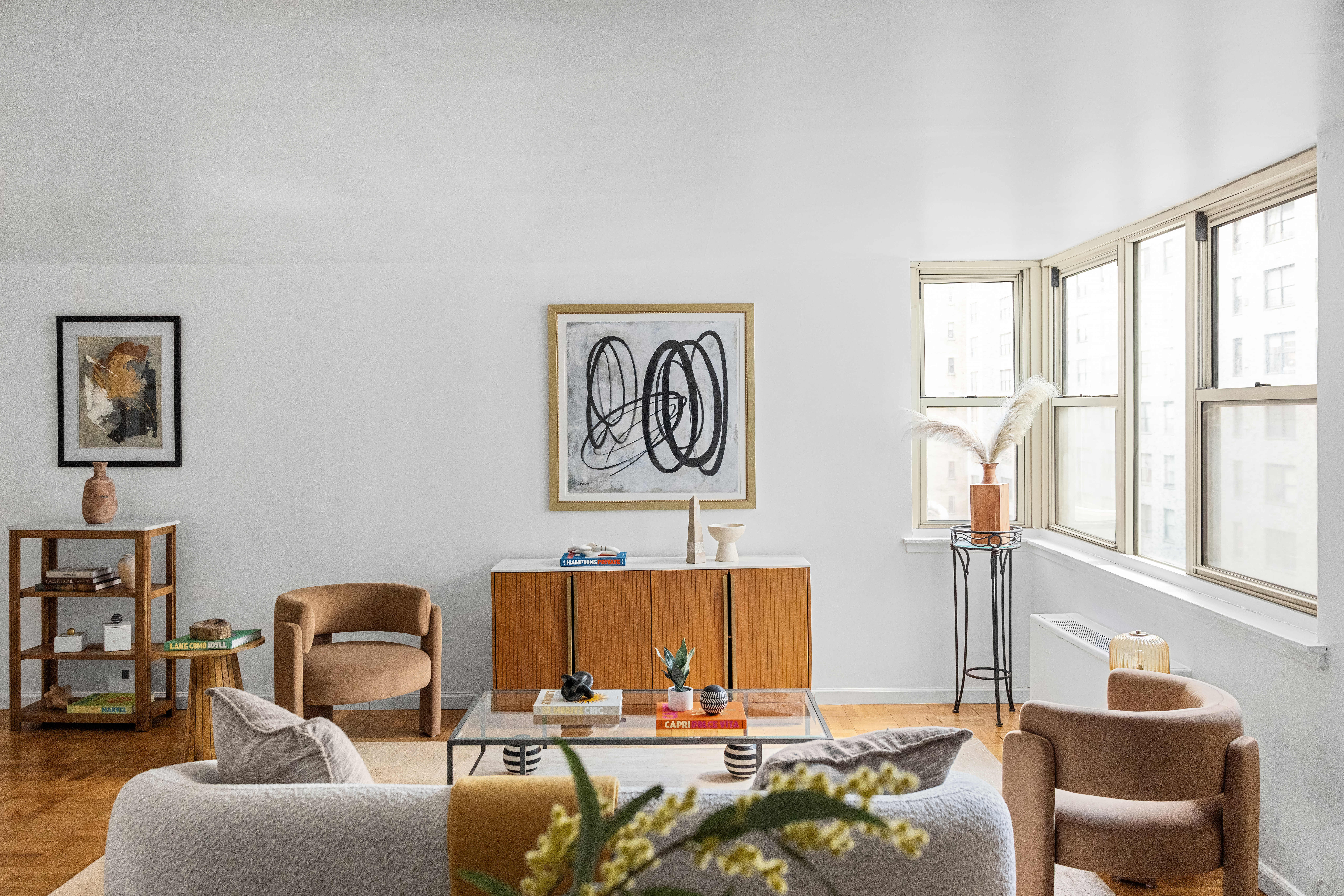 200 East 58th Street, Unit 6B Manhattan, NY 10022 - Photo 3 of 12 a living room with furniture and a large window