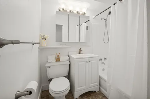 a bathroom with a sink a toilet and a mirror