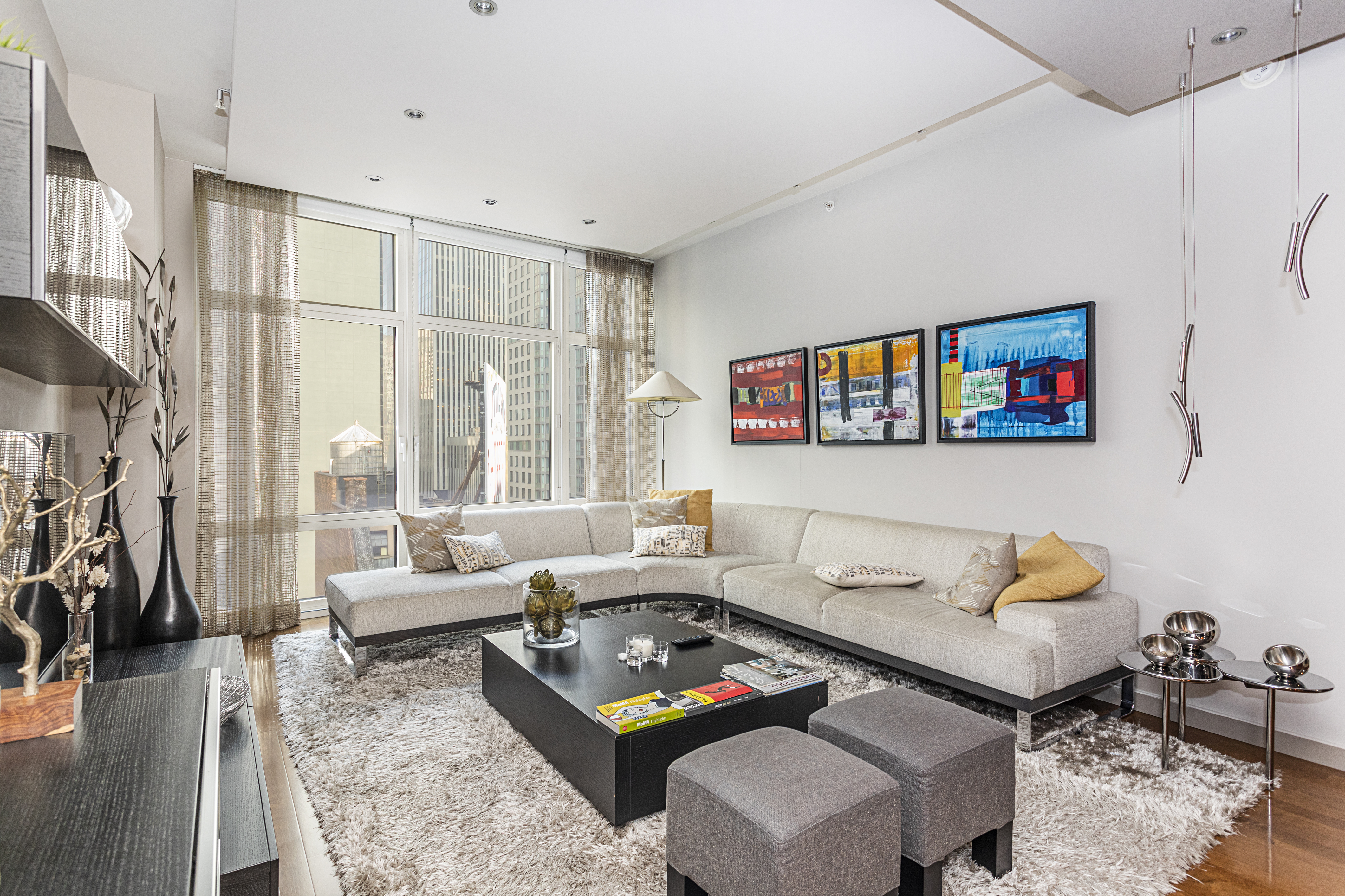 1600 Broadway, Unit 18G Manhattan, NY 10019 - Photo 1 of 10 a living room with furniture and a rug