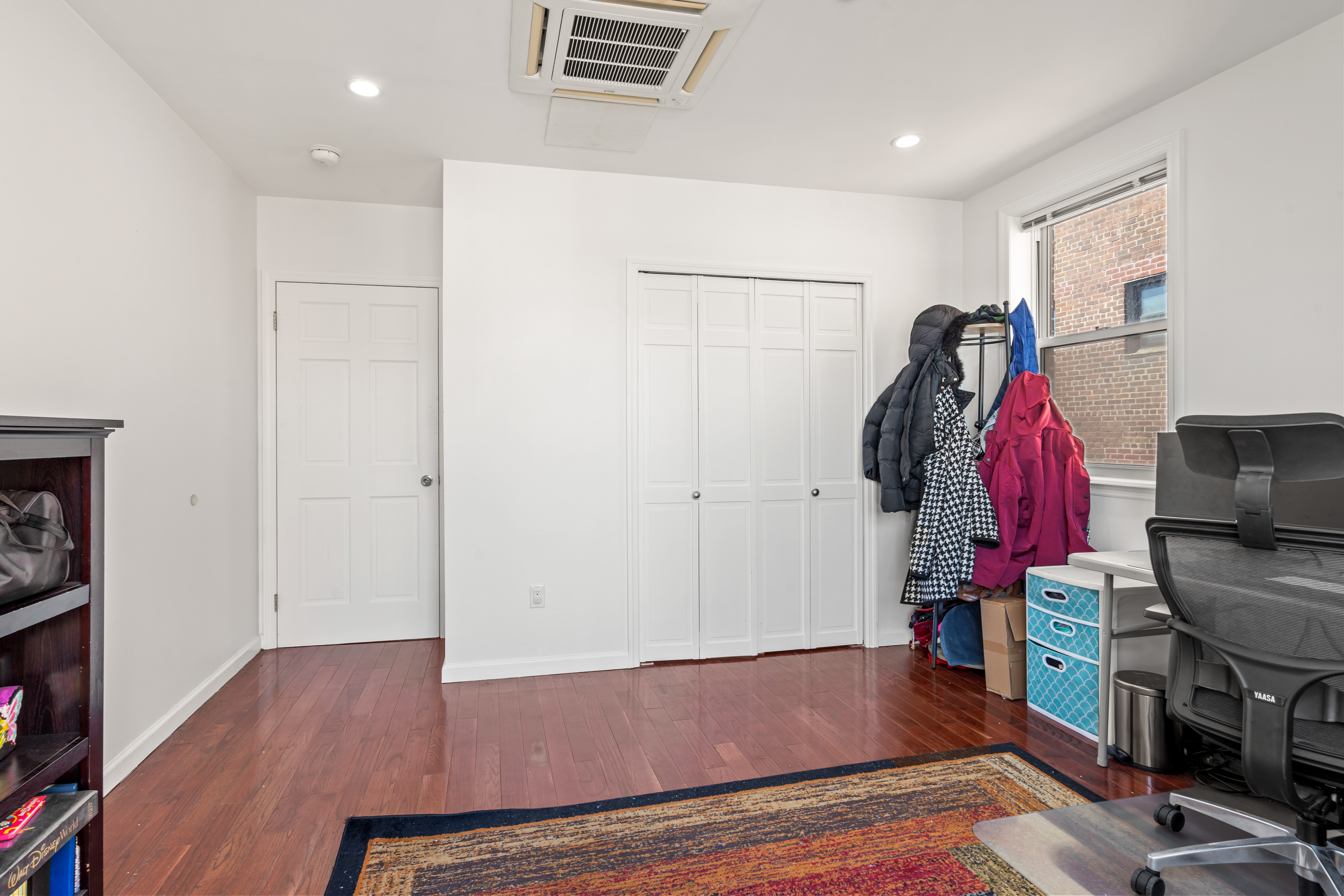 65-33 38th Avenue, Unit 5 Queens, NY 11377 - Photo 11 of 23 a view of walk in closet with clothes and shoes
