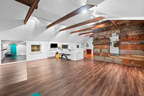 a living room with furniture and a stairs