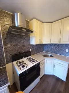 a kitchen with a sink a stove a microwave and cabinets