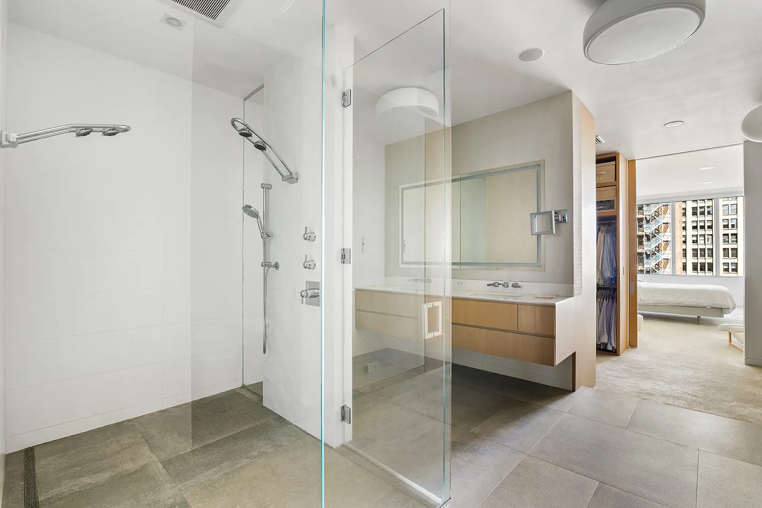 a bathroom with a tub shower sink and mirror
