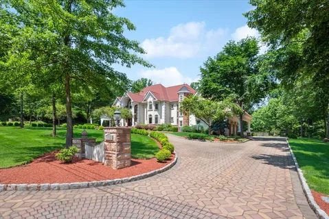 a front view of house with yard and green space