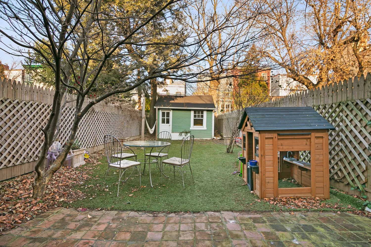 a backyard of a house with table and chairs