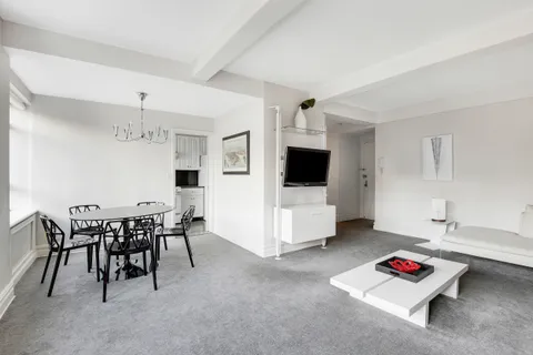 a living room with furniture and flat screen tv