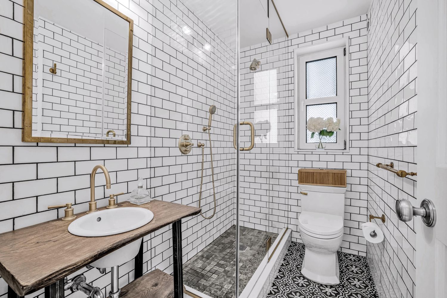 a bathroom with a toilet a sink and mirror