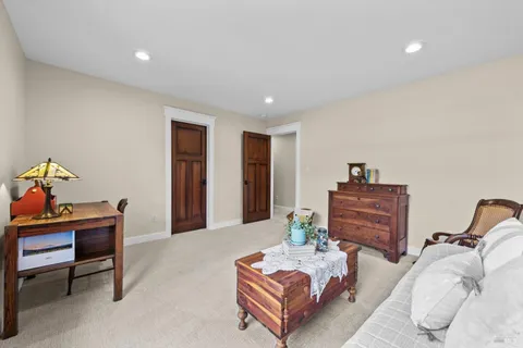 a view of house with a yard and large tree