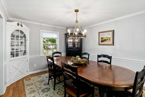 a dining room with furniture and window