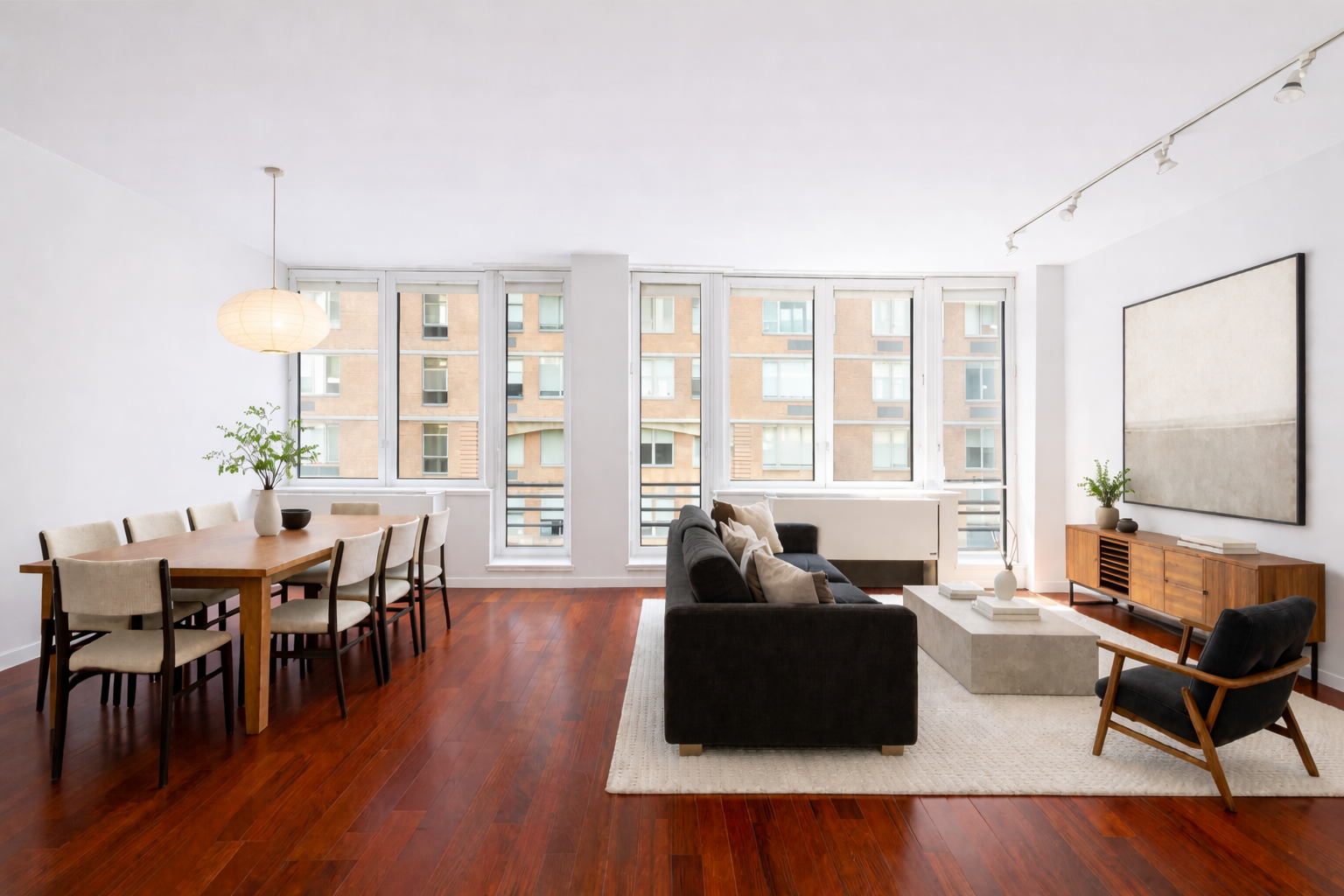 125 West 21st Street, Unit 5B Manhattan, NY 10011 - Photo 1 of 15 a living room with furniture a wooden floor and a large window