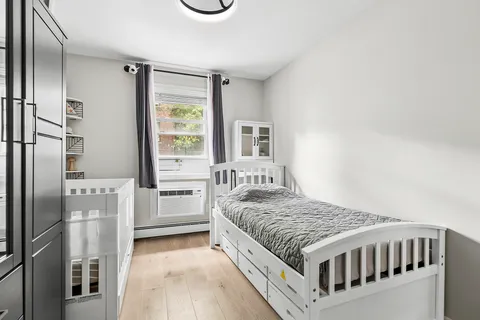 a bedroom with a bed and a window