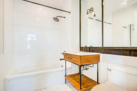 a bathroom with a bathtub and a sink