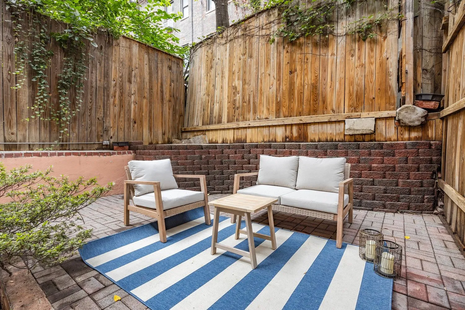 a building outdoor space with patio furniture and potted plants