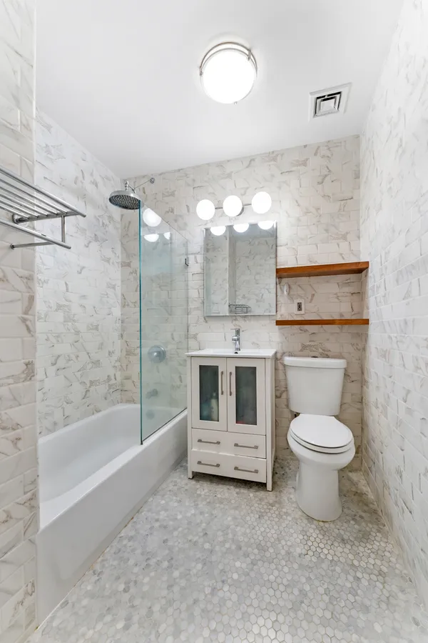 a bathroom with a sink a toilet and bathtub