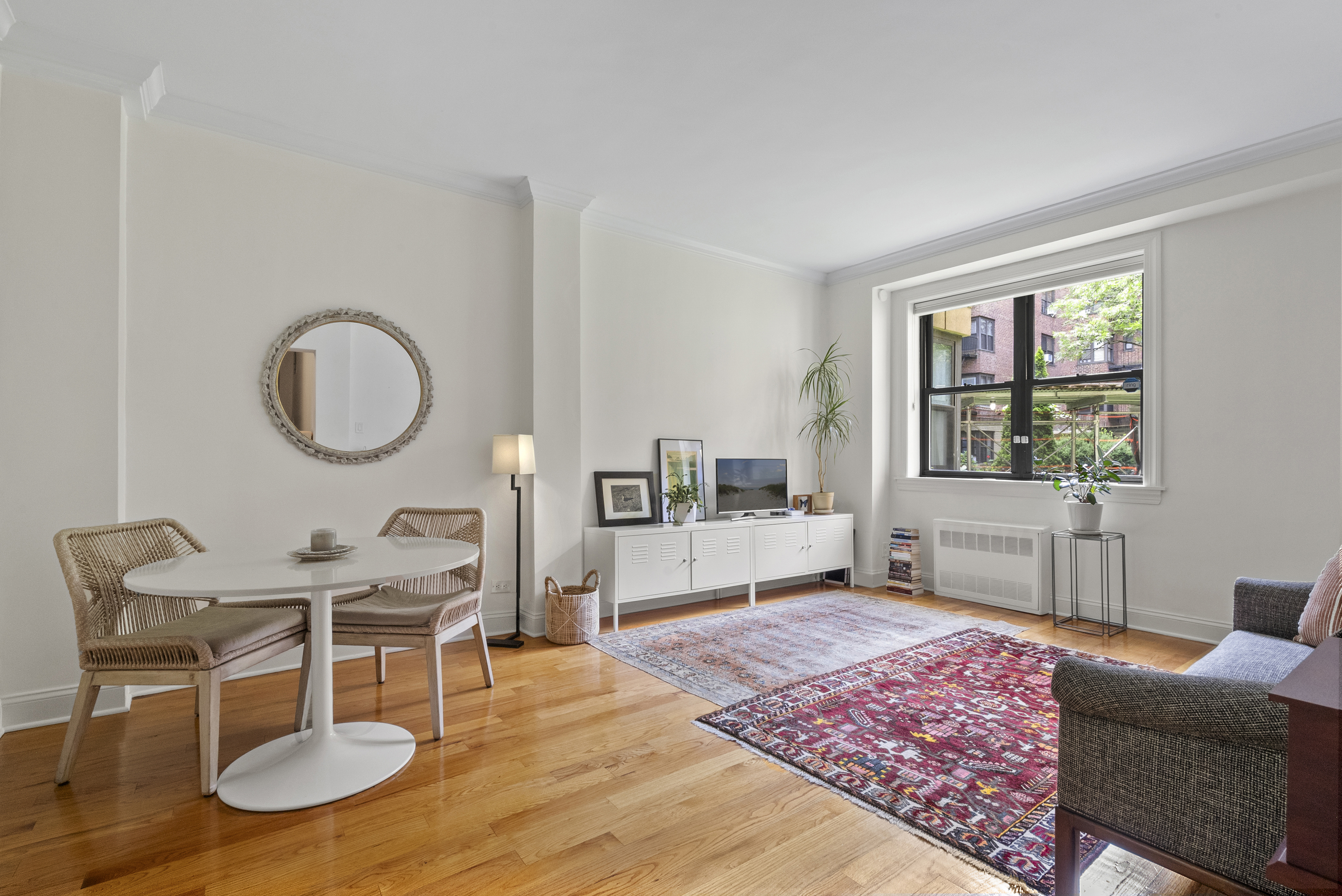 273 Bennett Avenue, Unit 3F Manhattan, NY 10040 - Photo 1 of 9 a living room with furniture a rug and a large window
