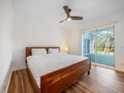 a bed sitting in a bedroom next to a window