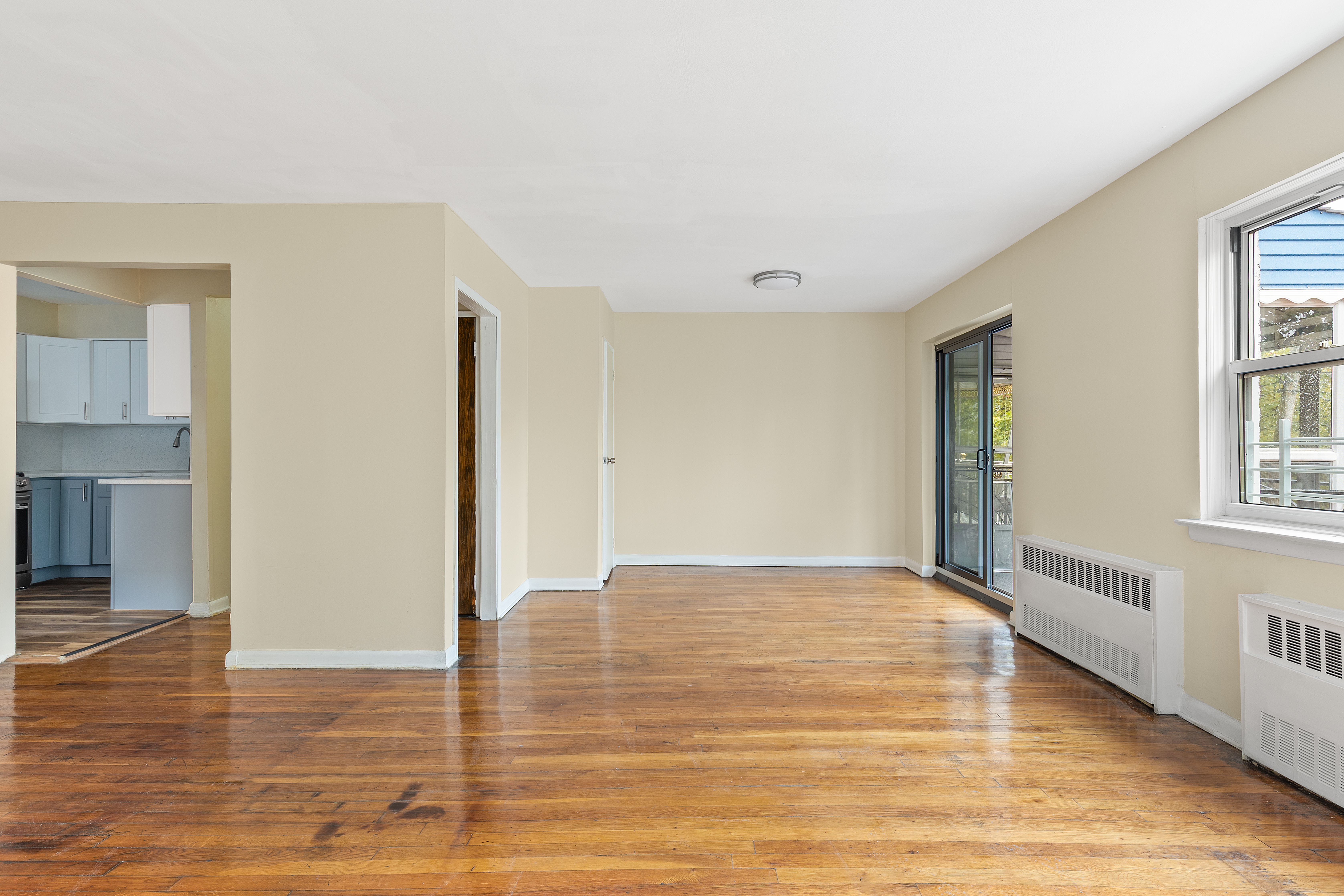 701 Rockaway Parkway, Unit 2F Brooklyn, NY 11236 - Photo 2 of 9 a view of an empty room with window and wooden floor