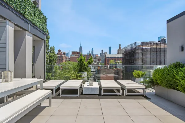 a terrace with outdoor seating and city view