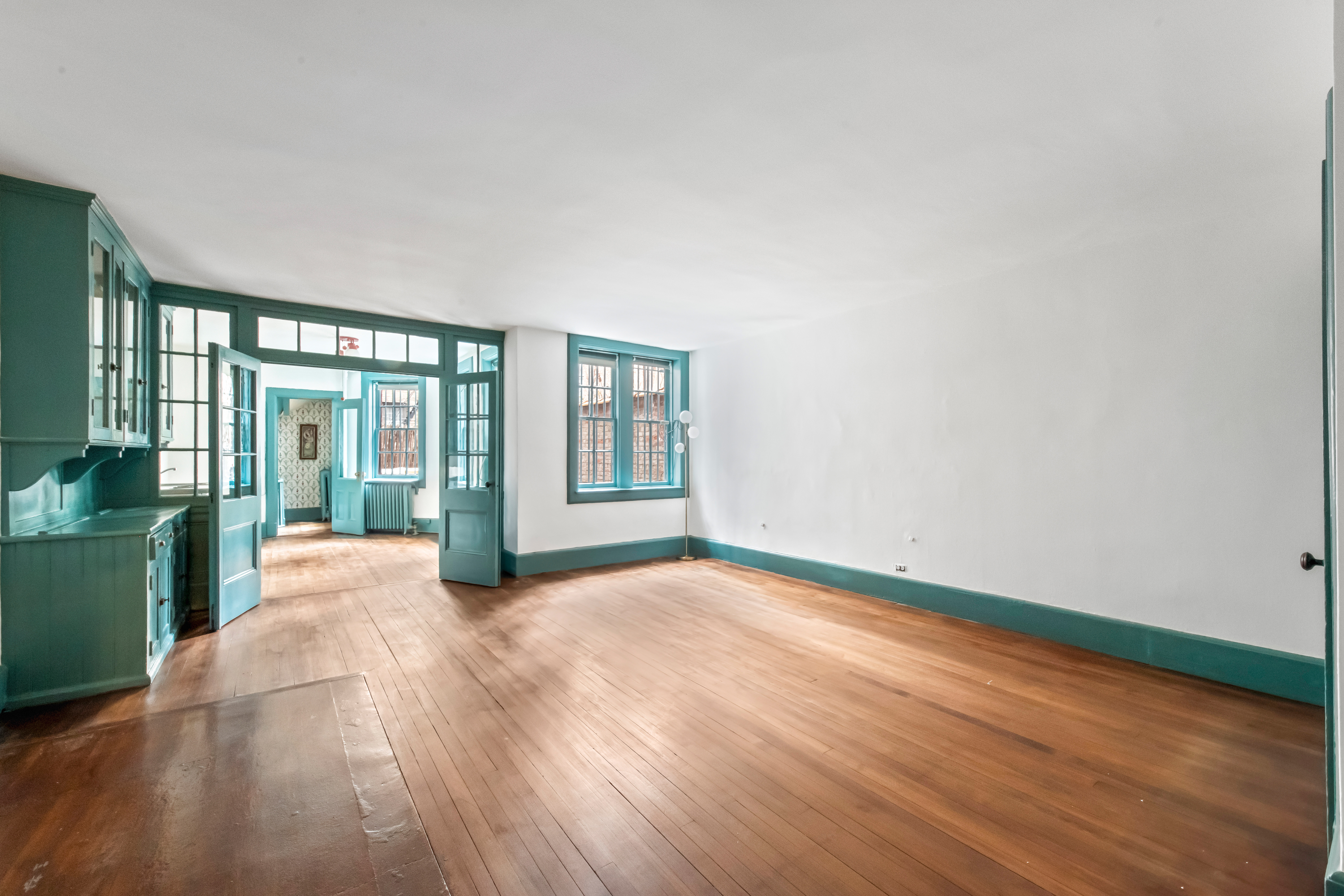 155 East 70th Street Manhattan, NY 10021 - Photo 7 of 27 a view of an empty room with wooden floor and a window