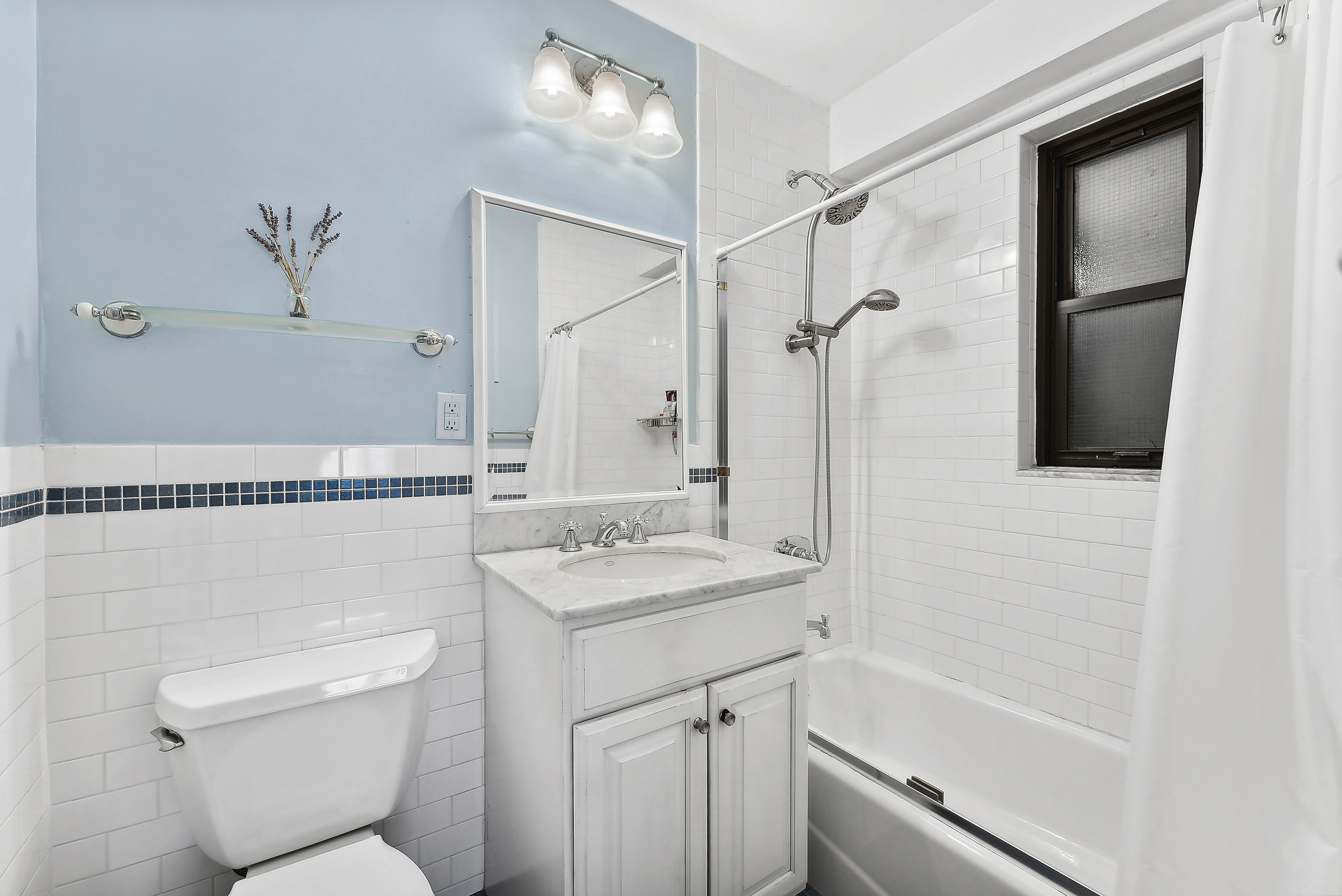 245 East 24th Street, Unit 10D Manhattan, NY 10010 - Photo 5 of 6 a bathroom with a sink a toilet and shower