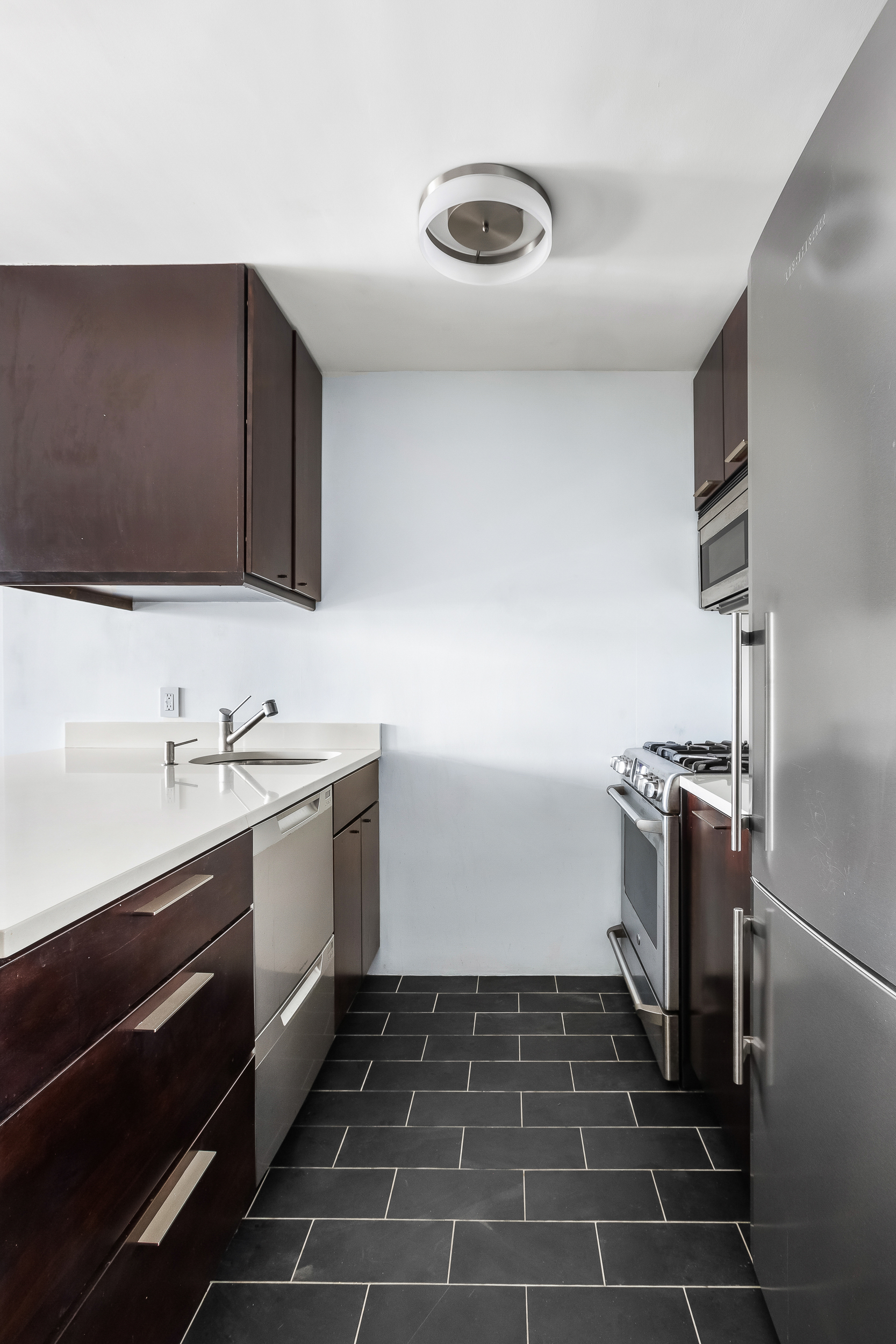 376 Broadway, Unit 14E Manhattan, NY 10013 - Photo 4 of 11 a kitchen with a sink and stainless steel appliances