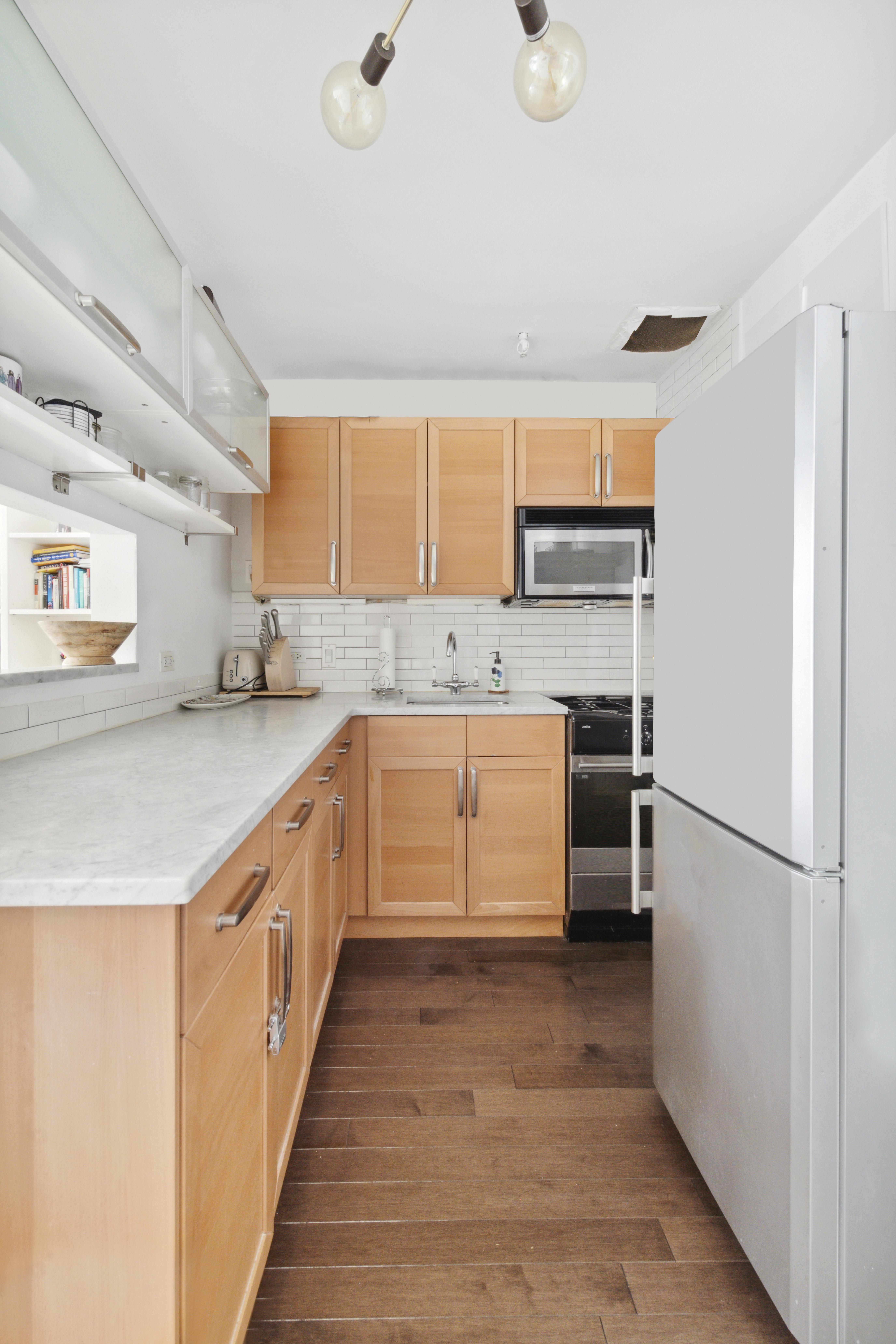 332 West 101st Street, Unit 4F Manhattan, NY 10025 - Photo 4 of 10 a kitchen with a sink a refrigerator and a oven