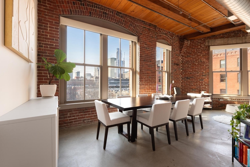 35 Channel Center Street, Unit 402 Boston, MA 02210 - Photo 2 of 35 a view of a dining room with furniture large windows and wooden floor