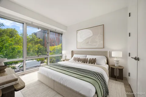 a bedroom with a large bed and a large window