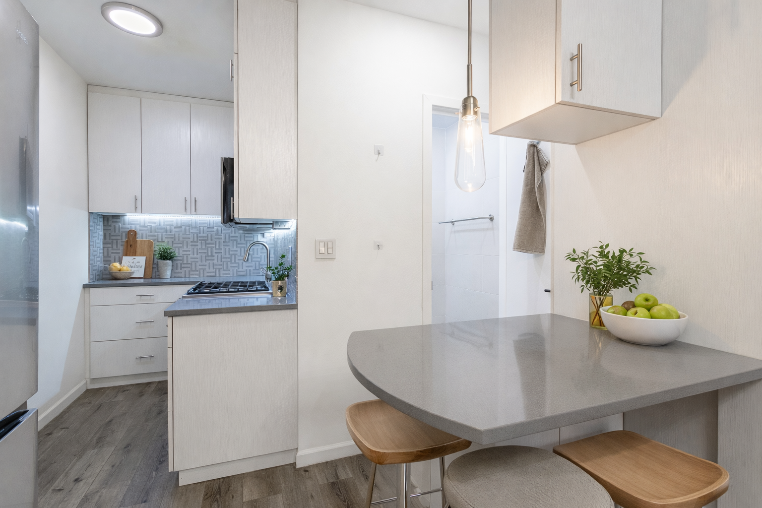 130 West 71st Street, Unit 1 Manhattan, NY 10023 - Photo 4 of 10 a kitchen with stainless steel appliances a table and chairs