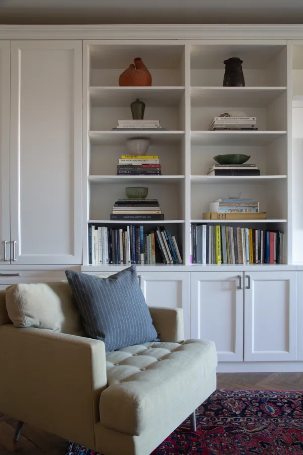 a living room with furniture and a book shelf