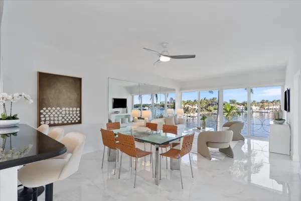 a dining room with furniture and a floor to ceiling window