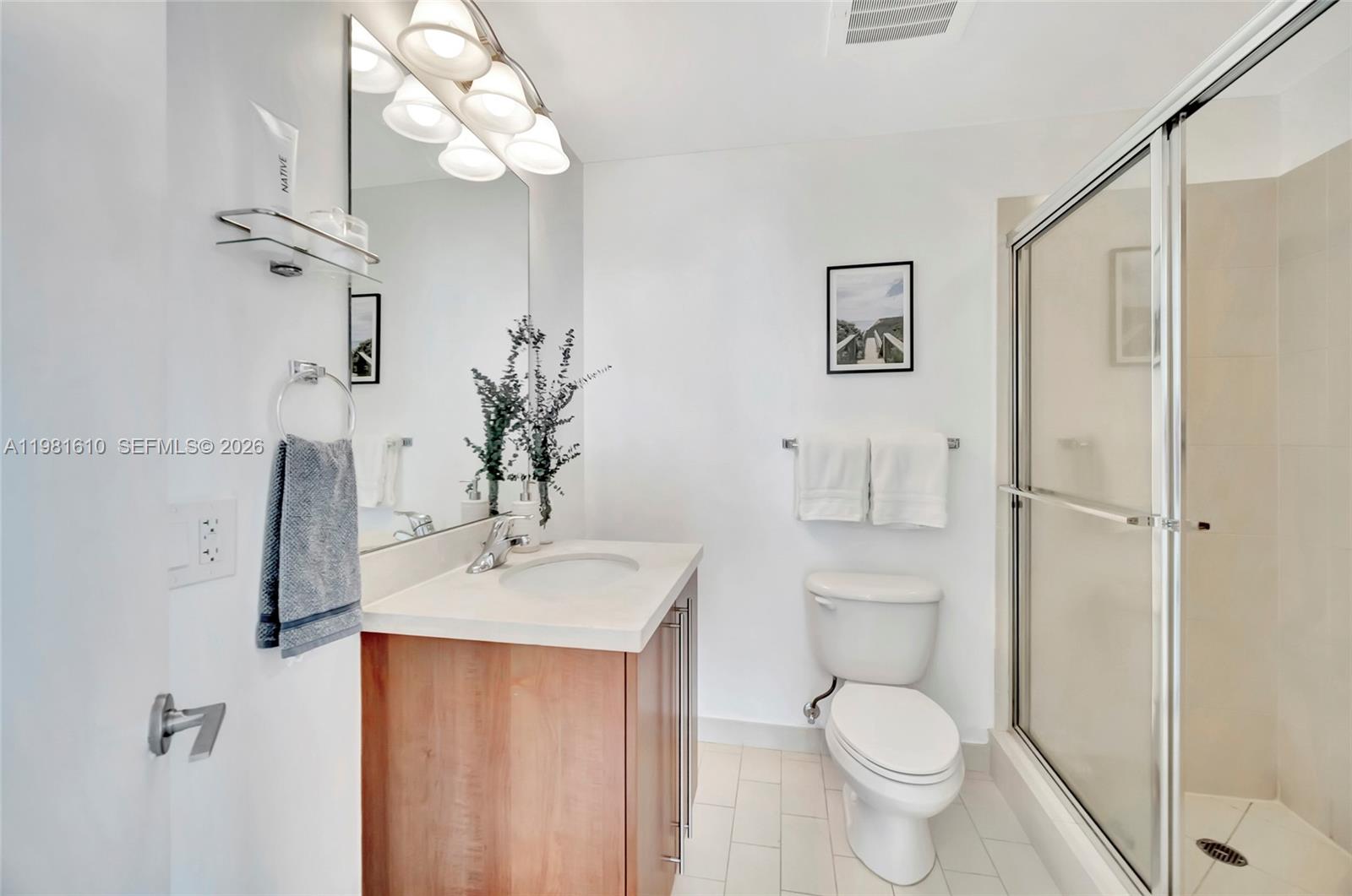 79 Southwest 12th Street, Unit 2201S Miami, FL 33130 - Photo 22 of 33 a bathroom with a toilet sink and mirror