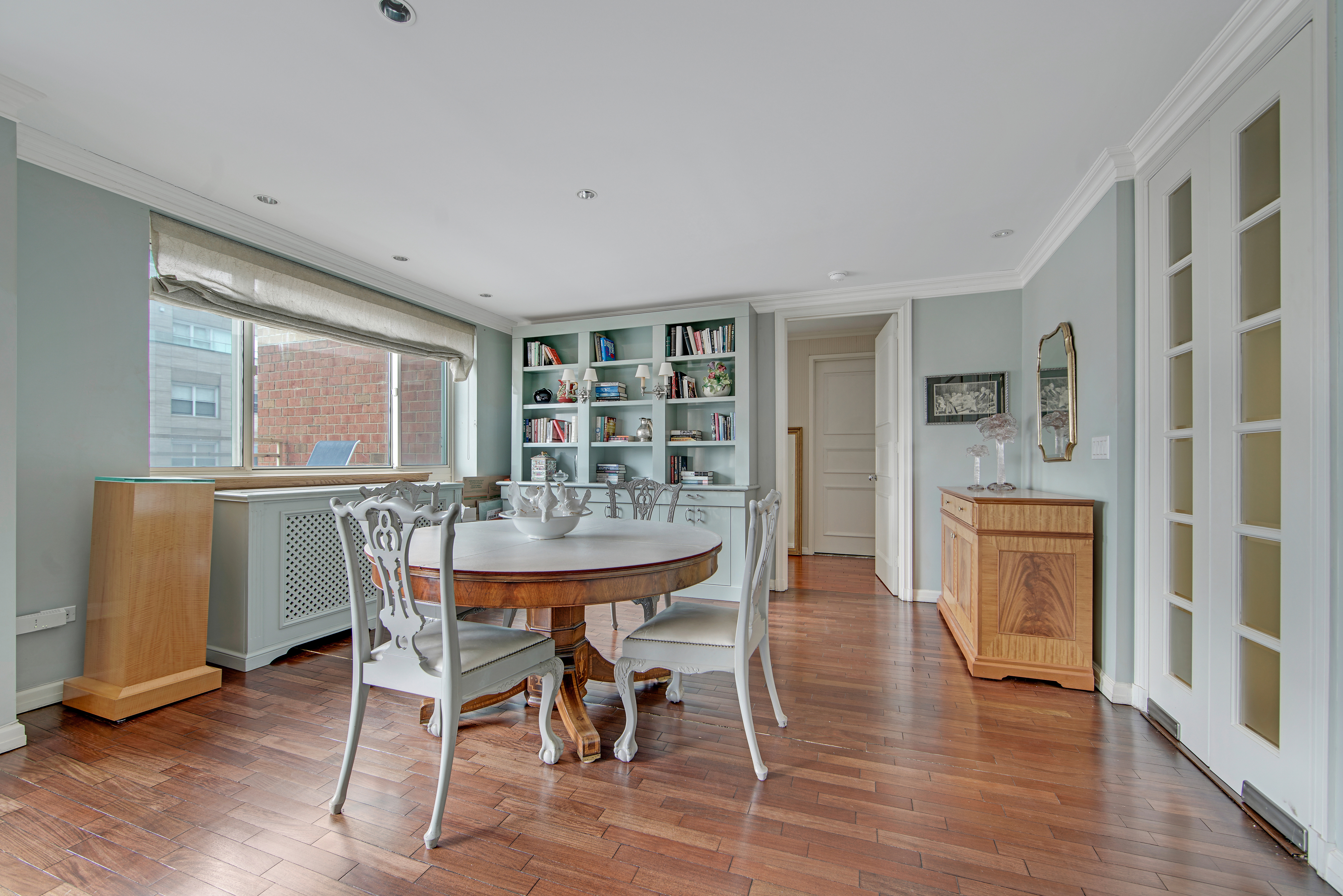 201 East 80th Street, Unit 16D Manhattan, NY 10075 - Photo 3 of 19 a view of a dining room with furniture window and wooden floor