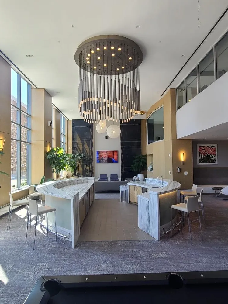 a living room with furniture a fireplace and a large window