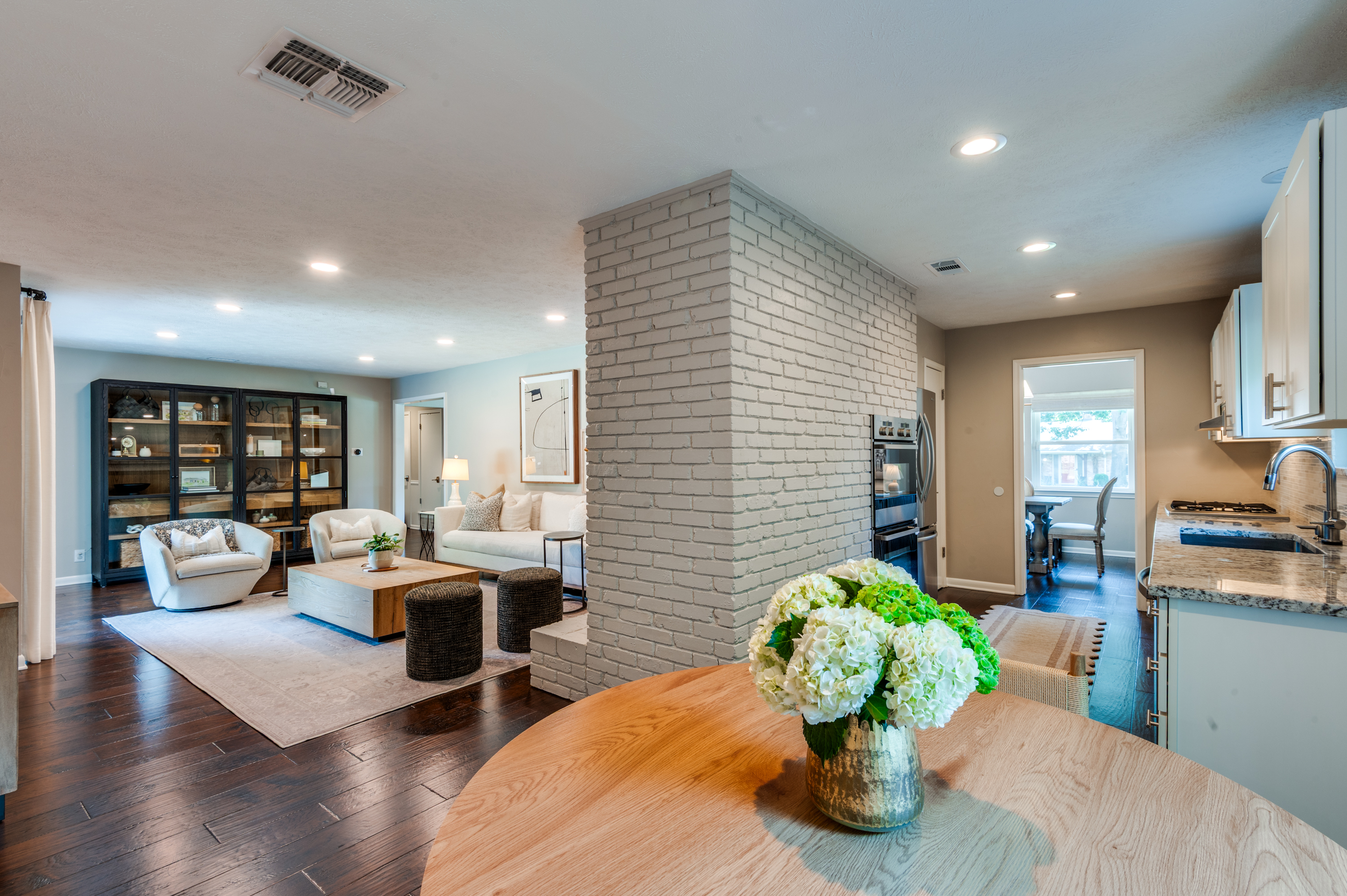 3363 Merrell Road Dallas, TX 75229 - Photo 11 of 29 a living room with fireplace furniture and a wooden floor