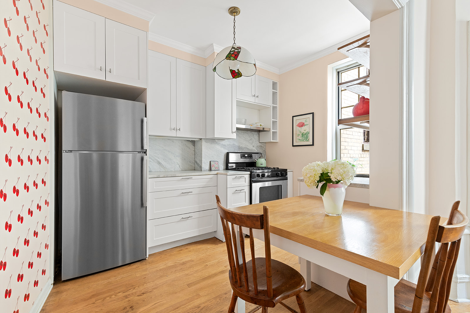 125 Prospect Park West, Unit 2E Brooklyn, NY 11215 - Photo 5 of 9 a kitchen with stainless steel appliances granite countertop a refrigerator and a stove top oven