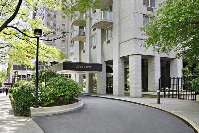 220 East 65th Street, Unit 8J Manhattan, NY 10065 - Photo 11 of 13 front view of a building with potted plants